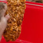Pet mouse nibbling on a nutritional treat supplement for small animals