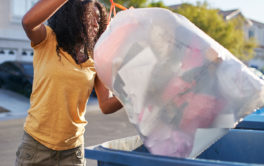 woman throwing out trash, disposing of flea and tick products