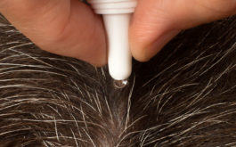 flea treatment being administered to a dog