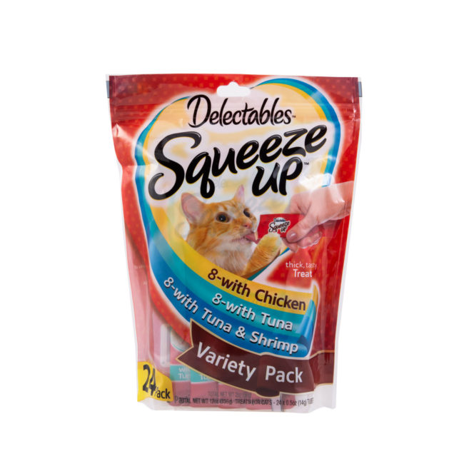 Delectables SqueezUp is the first gourmet wet cat treat where feeding is interactive. Front of package picturing a cat eating from a squeezeup tube being held by a hand.