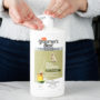 Hartz groomer's best professionals itch soothing dog shampoo. Pumping shampoo into hand. Hartz SKU# 3270012044