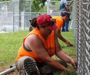 Rescue Rebuild volunteer repairing fence