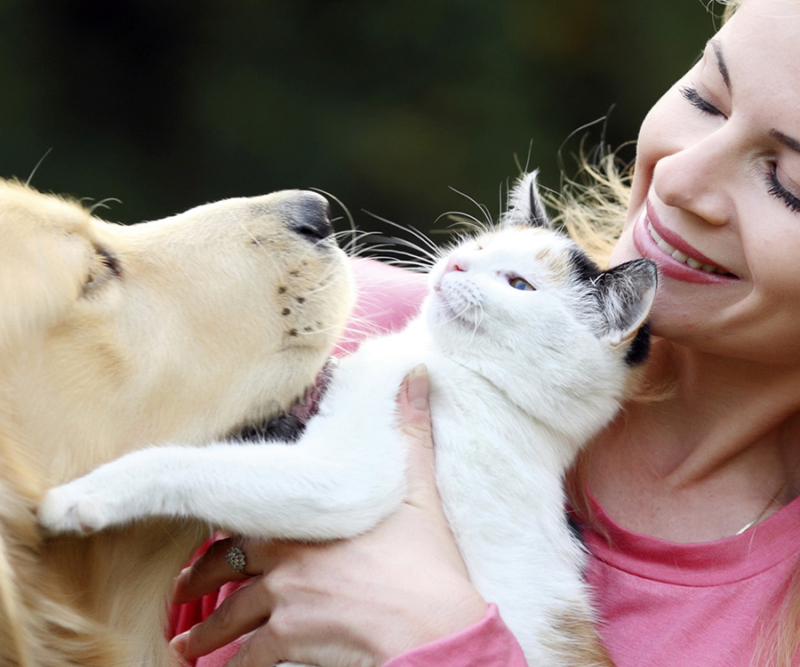 Woman with dog and cat - Should you get pet insurance?