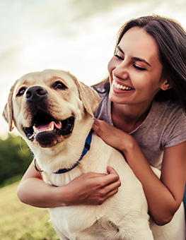 Young woman with dog labrador retriever.