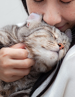 Woman cuddling and bonding with cat